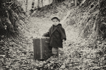 Lonely boy with suitcase, vintage