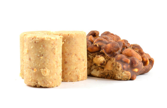 Brazilian "pe de moleque" (Portuguese for "boy's foot") peanut dessert typical for festa junina (June Festival) with pacoca (ground peanut candy)