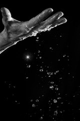 Obraz na płótnie Canvas Man's hand and water splashing.