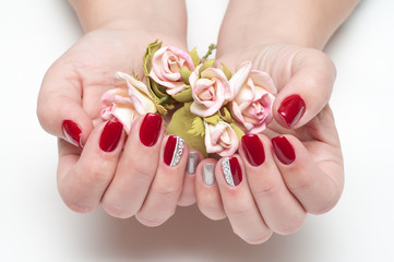 Burgundy, red manicure on long square nails with roses in hands with silver painting 