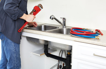 Plumber hand with wrench.