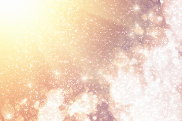 Golden rays and sparkles or glitter lights. Merry Christmas festive background.defocused circle bokeh or particles