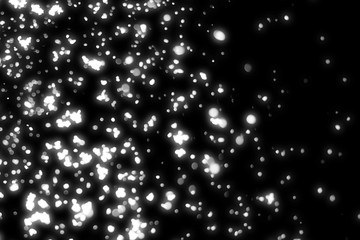 Snowfall isolated on black background. round bokeh or snowflakes particles . Design element