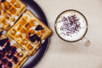 Breakfast in the kitchen. Coffee and Wafers with chocolate, cloudberries, blueberries and ice cream.