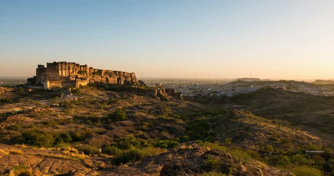 Jodhpur cityscape at sunset, time lapse. The majestic fort dominating the desert city, famous travel destination in Rajasthan, India.