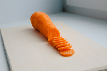 Sliced carrots with waves on a cutting board