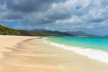 Fototapeta na wymiar Beautiful tropical beach with mild surf on sandy shore
