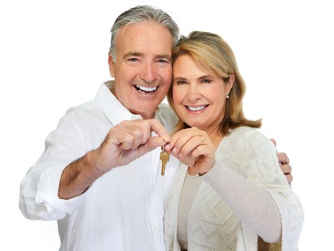 Senior couple with house key.