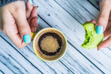 Woman holding a cup with tea at home
