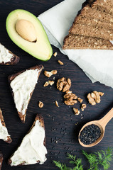 Sandwiches of rye bread with avocado and goat cheese