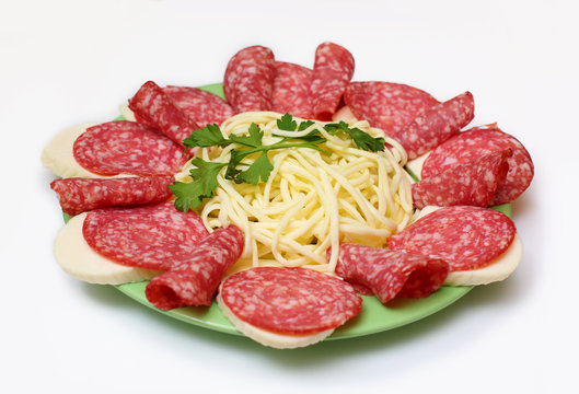 salami and cheese on a plate on white background