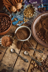 Roasted black and green coffee beans and ground coffee in the plate