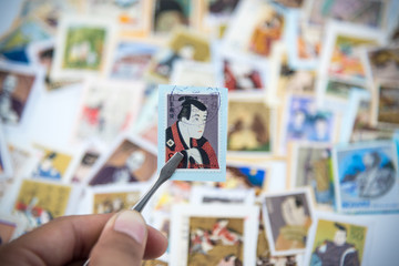 A postage stamp printed in Japan showing a painting of a Japanese people.