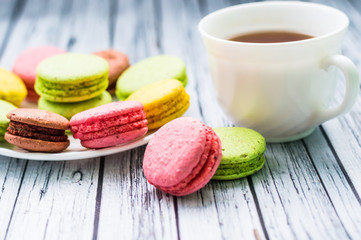 Still life with cup of tea and sweets on the wooden background