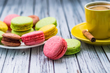 Still life with cup of tea and sweets on the wooden background