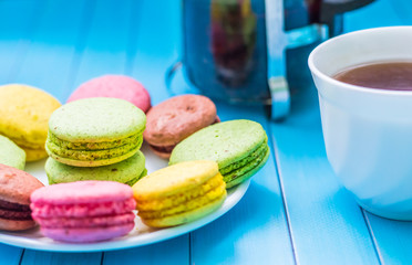 Still life with cup of tea and sweets on the wooden background