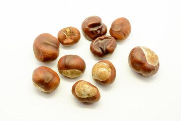 Closeup chestnuts isolated on white background. Fresh autumn chestnut. Sweet natural fruit the chestnut tree. Sign of autumn. Autumn decoration from chestnuts.