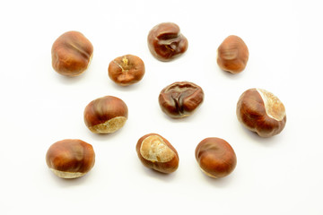 Closeup chestnuts isolated on white background. Fresh autumn chestnut. Sweet natural fruit the chestnut tree. Sign of autumn. Autumn decoration from chestnuts.