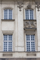 Fototapeta na wymiar Four vintage design windows on the facade of the old house.