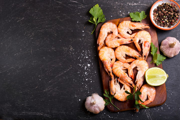 shrimps with lime on dark table
