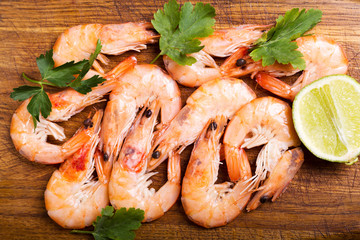 shrimps with lime on wooden table