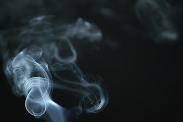 mystery wavy smoke rising over black background