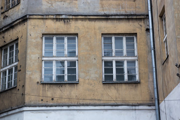 Fototapeta na wymiar Windows on the facade of an old abandoned house