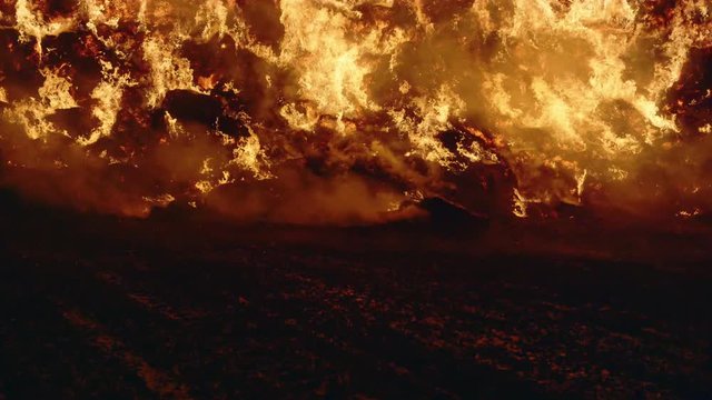 Fire storm, horrific fire destroys gigantic hay bales construction, Red Epic slow motion clip