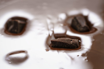 pieces of dark chocolate drowning in melted