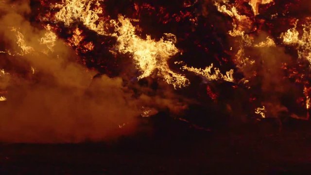 Fire storm, horrific fire destroys gigantic hay bales construction, Red Epic slow motion clip