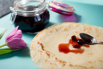 Russian pancakes with cherry jam for breakfast