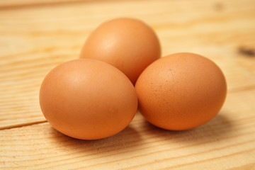 White eggs on burlap over wooden background