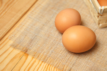 Fresh farm eggs on a wooden rustic background