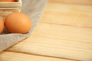 Fresh farm eggs on a wooden rustic background