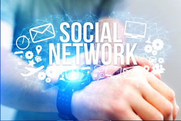 Concept of man holding futuristic interface with social network  title and multimedia icons flying all around - Internet concept