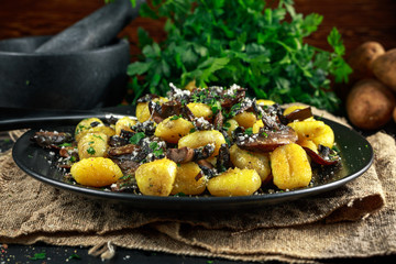 Home made potato gnocchi with mushrooms, chopped parsley and parmesan cheese