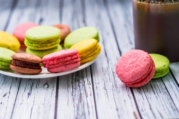 Still life with cup of tea and sweets on the wooden background