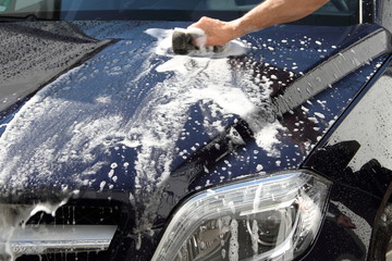 Auto mit einem Schwamm waschen 
