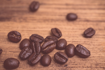 Roasted coffee beans on wood texture background