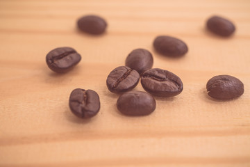 Roasted coffee beans on wood texture background