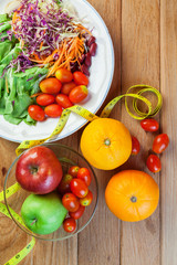 Healthy concept with mixed fruits and vegetables on wooden background