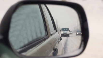 View of the highway through car the wing mirror