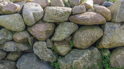 Field stone wall in the garden at sunshine - 142106990