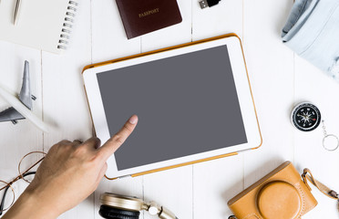 Hand touching blank tablet mock up screen for travel and tourism theme