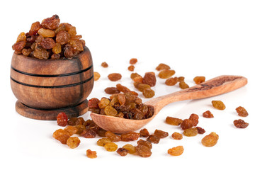 raisins in a wooden bowl with spoon isolated on white background