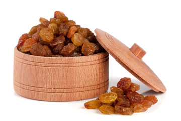 raisins in a wooden bowl isolated on white background