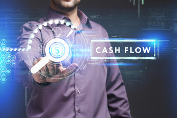 Business, Technology, Internet and network concept. Young businessman working on a virtual screen of the future and sees the inscription: Cash flow