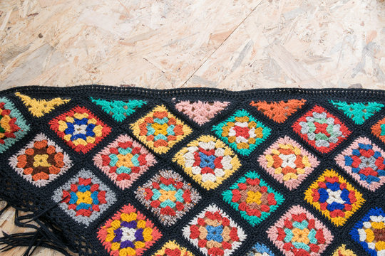 Diagonal layout of handmade blanket made from granny squares - copyspace