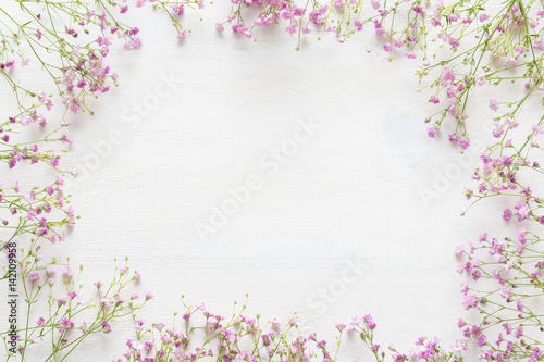 White wooden table with pink flowers, welcome spring concept