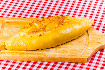 Adjarian Khachapuri on wooden board
